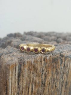 Gold Five stone dainty band ring. Gold July ruby ring. Five rubies Round Ring, Classic ring. Great gift. handmade. anniversary, valentine This is a goldfilled ring. Its a five stone ring, A delicate designer handmade ring which has a raw design. The ring is set with 5 rubies stones. You can choose you're favorite gemstone or birthstone from: blue topaz, citrine, moonstone, garnet and smoky quartz. This ring can be also be one of a stacking casual ring set. This ring is made with high quality 14k Ruby Stackable Round Band Promise Rings, Ruby Birthstone Ring With Bezel Setting, Gold Stackable Rings With Ruby Bezel Setting, Ruby Stackable Rings With Birthstones, Stackable Ruby Birthstone Rings With Round Band, Stackable Ruby Birthstone Rings, Ruby Ring With Bezel Setting And Round Band, Gold Stackable Ruby Ring, Fine Jewelry Ruby Stackable Rings