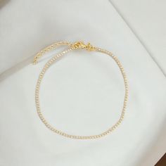 The Baby Tennis bracelet is the perfect way to add an ultra dainty touch of sparkle to your bracelet stack. It is gold-filled so it can be worn in the shower. Chain Width: 1mm (super tiny) Chain Length: Adjustable between 6.5” and 7.5” inches Stones: 5A Cubic Zirconia 18k Gold filled Handle with care and avoid contact with chemicals. Stacked Necklaces, Handle With Care, Gold Gemstone Ring, Dainty Necklace, Tennis Bracelet, Bracelet Stack, Chain Lengths, Chain Length, Chain Bracelet