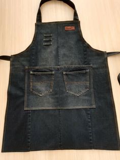 an apron made out of denim with two pockets