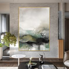 a living room with a large painting on the wall and coffee table in front of it