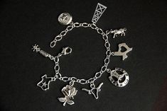 A collection of silver plated Texas themed charms have been dispersed around a shimmering silver plated bracelet chain in this handmade charm bracelet. This Texas charm bracelet is then completed with a lobster clasp and a 1/2 inch of chain at the end for adjustable sizing. Charms in this bracelet include two Texas state charms, a lone-star charm, an oil rig charm, bull charm, Texas rose charm, boot spurs charm, horseshoe with cowboy boots charm, and a long horn charm. ● Sizing ● To determine yo Silver Symbolic Bracelets With Dangling Charms, Symbolic Silver Bracelets With Dangling Charms, Silver Metal Chain Bracelet With Dangling Charms, Symbolic Silver Bracelet With Dangling Charms, Symbolic Sterling Silver Charm Bracelet, Personalized Symbolic Silver Bracelets, Symbolic Silver Bracelets With Charms, Silver Adjustable Chain Bracelet With Dangling Charms, Adjustable Silver Chain Bracelet With Dangling Charms