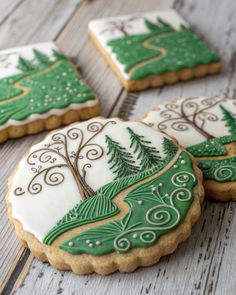 cookies decorated with green and white icing sitting on a table