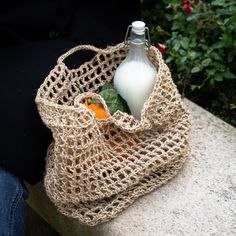 a handbag with a bottle of milk in it