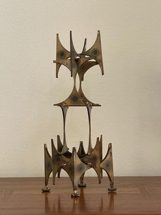 a metal sculpture sitting on top of a wooden table