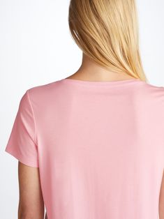 Our women's pink leisure t-shirt is an effortlessly chic sport-luxe essential. The Lara fabric is a slightly lighter weight than Basel but has enough coverage to be worn out of the house and also offers good breathability, making it perfect for warmer climates. Not only is the Lara versatile, it has maintained the super-soft fabric quality and stretch composition that we know you love. What's more, the Lara fabric retains its initial softness and colour and is also responsibly and ethically sourced; spun and knitted in Europe. To make it truly special, we can personalise your garment with initials or a motif. Read more about our personalised services here. The model is 5’10” / 178cm tall with waist size 25” / 63cm, bust size 32” / 82cm. She wears a size Small. Pink Shirttail Hem Top For Summer, Casual Modal T-shirt, Pink Scoop Neck Athleisure Top, Pink V-neck Athleisure Top, Pink Fitted Cotton T-shirt, Pink Relaxed Fit T-shirt For Sports, Pink Relaxed Fit T-shirt In Organic Cotton, Pink Organic Cotton Crew Neck T-shirt, Pink Crew Neck