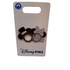 two disney pins sitting on top of a white box