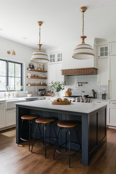 a kitchen island with stools in front of it