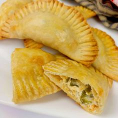 three small pastries on a white plate