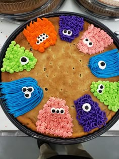 there is a cake decorated to look like sesame street characters on the plate with googly eyes