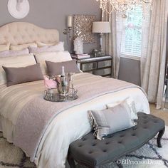 a bedroom with a large bed and chandelier