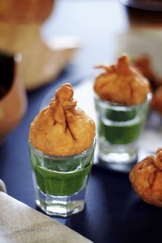 two small cups filled with food on top of a table