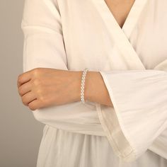 Add luxury and beauty to your look with this pearl bracelet. White pearls are gracefully arranged in a single strand for a refined look. Each lustrous pearl, meticulously chosen for its radiant luster, exudes natural beauty. Subtle and elegant, this bracelet will compliment both casual and dressy outfits. A delicate piece perfect for everyday wear or special occasions. *Each piece is handmade, resulting in a potential variance of 0.1-0.2mm during measurement. Please refer to the actual item for Timeless White Pearl Jubilee Bracelet, Elegant Formal Pearl Oyster Bracelet, White Beaded Bracelets With Oyster Style For Formal Occasions, Elegant White Pearl Beaded Bracelets, Formal Beaded Bracelets With Pearl Drop, White Beaded Oyster Bracelet For Formal Occasions, White Beaded Oyster Bracelets For Formal Occasions, Elegant White Beaded Bracelets, Elegant Sterling Silver Bracelet With Round Beads For Anniversary