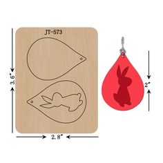 a wooden stamp with a red rubber keychain and an image of a rabbit on it