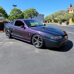 a purple sports car parked in a parking lot