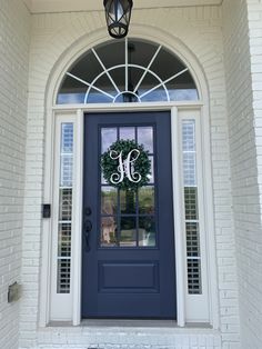 a blue front door with the letter h on it