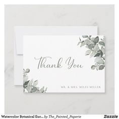 a white thank card with green leaves on it