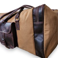 a brown and tan duffel bag sitting on top of a white surface