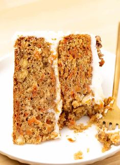 a piece of carrot cake on a plate with a fork