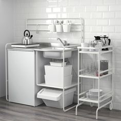 a kitchen with white appliances and dishes in it