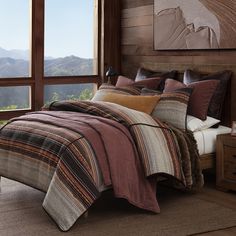 a bedroom with a large window overlooking the mountains