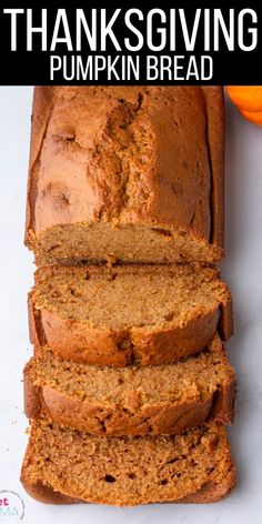 a loaf of pumpkin bread sitting on top of a white counter next to an orange