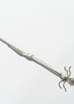 a long metal object with an octopus on it's side and two balls attached to the end