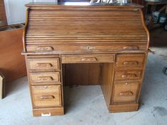 an old wooden desk with drawers on it