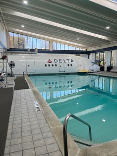 an indoor swimming pool with tiled floors and walls