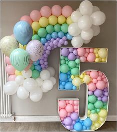 the number five is surrounded by balloons and streamers