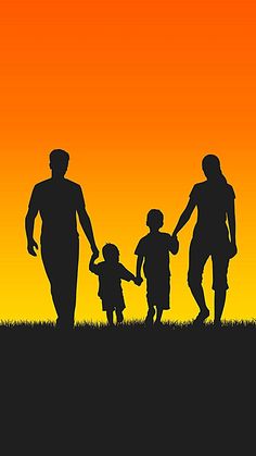 a family walking in the grass at sunset with an orange and yellow sky behind them