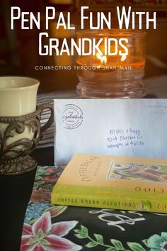 a table topped with books and a cup filled with liquid sitting on top of it