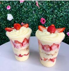 two dessert cups with strawberries on top