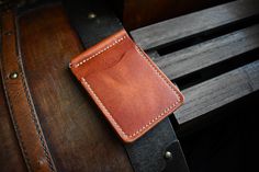 This traditional money clip wallet is handcrafted with full grain Horween leather. There are a total of four card pockets that will hold multiple cards in each slot. This wallet comes with a spring clip in the middle that will hold your cash securely. This product is available for free personalization! FEATURES - 100% handmade in the USA - Guaranteed to last a lifetime - Complimentary personalization - Great for gifts - Full grain leather - Leather will age and patina beautifully over time - All edges are finished and polished by hand - Medium to firm temper leather - Made with leather sourced from renowned American tanneries DIMENSIONS: 3" x 4.3" (closed) LEATHERS We use full-grain leather sourced from renowned American tanneries, primarily utilizing Horween Dublin leather, known for its Handmade Leather Wallets For Everyday Carry, Handmade Rectangular Wallets For Everyday Carry, Handmade Rectangular Wallet For Everyday Use, Handmade Rectangular Wallet For Everyday Carry, Handmade Everyday Rectangular Wallet, Handmade Rectangular Everyday Wallet, Handmade Classic Wallet, Leather Money Clip, Leather Money Clip Wallet