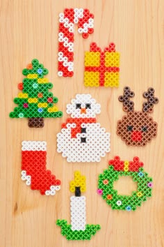 christmas decorations made out of legos on a wooden surface