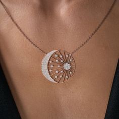 A shimmering starburst of The Distance Eclipse Pendant round brilliant diamonds explodes from a stunning cluster, spreading its sun-inspired rays to a pave diamond crescent moon. The Distance Eclipse Pendant is a beautiful ethereal necklace. Shimmering diamonds dance in the sparkles of light while the delicate setting rests effortlessly on the neckline. The piece is elevated and elegant. The perfect gift for the stargazer in your life. Crescent Moon, Pave Diamonds, Round Brilliant, Crescent, Diamond Necklace, Diamonds, Sparkle, Yellow Gold, White Gold