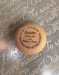 a wooden stamp with the names and date on it sitting on top of a table