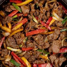 beef and peppers stir fry in a wok with seasonings on the side, ready to be eaten