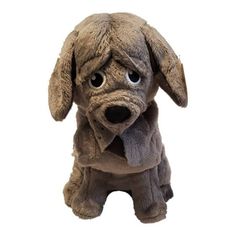 a stuffed dog with big eyes sitting down