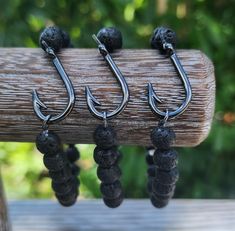 Fish hook stretch bracelet! Hook is gunmetal and measures 26x16mm.  Stretch bracelet with 8mm black lava rock beads. *All bracelets are made from a thick stretchy material. I make a variety of sizes, but most are made to stretch over and fit an average size wrist. Please include with purchase if it is for a very small wrist or larger wrist and I will send one of that size. Fish Hook Bracelet, Indian Rocks Beach, Hook Bracelet, Lava Rock, Bead Designs, Fish Hook, Stretch Bracelet, Stretch Bracelets, Stretchy Material