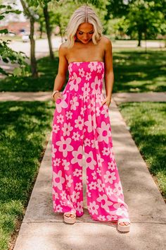 - Channel your inner flower child with this trendy jumpsuit! - Lightweight material with a flower print and a built-in shorts cut lining - A strapless neckline - A smocked bodice - Hidden side pockets - A flowy yet flattering silhouette that ends in straight floor length hemlines Spring Vacation Strapless Jumpsuit With Smocked Bodice, Summer Strapless Jumpsuits And Rompers With Elastic Waistband, Strapless Jumpsuits And Rompers With Elastic Waistband For Vacation, Summer Bandeau Jumpsuits And Rompers With Elastic Waistband, Summer Bandeau Jumpsuit With Elastic Waistband, Bandeau Jumpsuits And Rompers With Elastic Waistband For Spring, Strapless Beach Jumpsuits With Smocked Bodice, Summer Strapless Jumpsuit With Elastic Waistband, Bohemian Jumpsuits And Rompers With Smocked Back For Spring