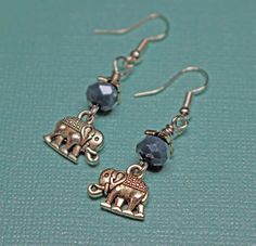 These are a cute and simple 20x10mm silver plated little elephant earrings.  The little elephant is dangling from a 8mm faceted teal glass bead.  The earring has a drop of 1 1/2 inches and the ear wire is hypoallergenic. Teal Glass, Elephant Earrings, White Elephant, Etsy Earrings Dangle, Ear Wire, Glass Bead, Jewelry Earrings Dangle, Beading, Silver Plated