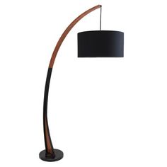 a floor lamp with a black shade on the base and a wooden pole in front of it