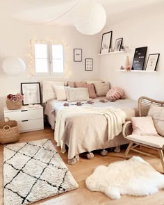 a bed room with a neatly made bed and pictures on the wall