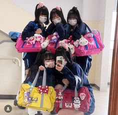 four girls wearing face masks and carrying luggage