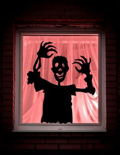 a shadow of a person in front of a window with arms and hands on it