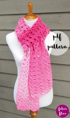 a pink crocheted scarf on a mannequin