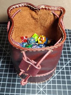 This is a handmade leather dice bag for your tabletop adventures. The colors in leather we have to offer varies Leather Pouch With Case Included For Gift, Gift Leather Pouch With Case Included, Leather Pouch Bag With Pen Holders, Leather Bucket Pouch As Gift, Leather Dice Bag, Ditty Bag, Dice Bag, Savannah Ga, Coin Purses