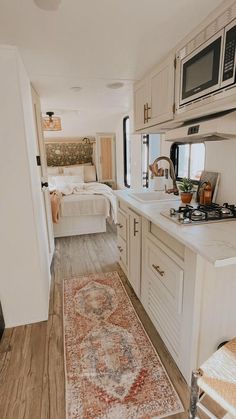 a kitchen with a rug on the floor