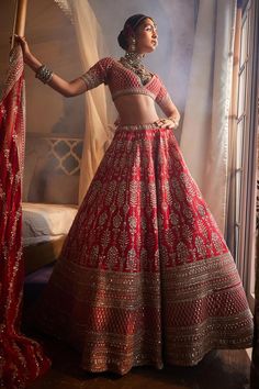 Red raw silk lehenga with attached can-can, all over floral stripe pattern, metallic zardozi and sequin hand embroidery. Paired with jaal embroidered padded blouse and net stripe embroidered dupatta.
Components: 3
Pattern: Hand Embroidered
Type Of Work: Zardozi and Sequin Work
Neckline: Plunged V Neck
Sleeve Type: Half Sleeves
Fabric: Raw Silk, Dupatta: Net
Color: Red
Other Details: 
Cut work dupatta hem
Lehenga Length: Approx 43 - 44 inches
Occasion: Bride,Reception - Aza Fashions Raw Silk Lehenga, Lehenga Red, Padded Blouse, Red Lehenga, Embroidered Lehenga, Embroidered Dupatta, Silk Lehenga, Net Dupatta, Silk Dupatta