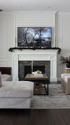 a living room with two couches and a television on the fireplace mantel in it